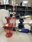 A selection of antique cranberry and similar glass wares including Bristol blue rolling pin,