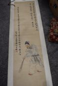 A Chinese paper scroll having painting of gent in traditional dress and symbols.