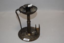 A 19th century German 'Goberg' (Hugo Berger) Arts & Crafts iron chamber stick, with matchbox holder,