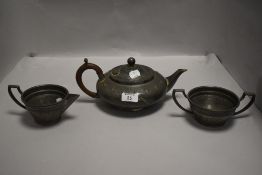 An art deco hammered pewter trio comprising of teapot,sugar and cream.