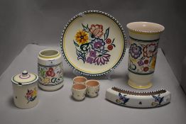 A collection of Poole pottery having floral patterns.