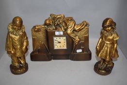 An art deco French style mantle clock and garniture set in a Pierrot clown design