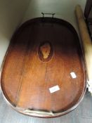 An Edwardian mahogany framed butlers tray having brass handles