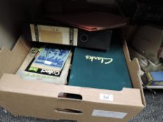 A selection of stamp albums, loose stamps and stamp collecting magazines.