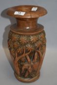 A turned vase of pale coloured hard wood having elephant and tree carving,possibly Indian.