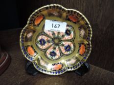 A Crown Derby Imari patterned pin dish of lobed circular form.