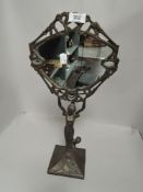 An art nouveau style make up mirror having cast metal figural base in a Tiffany style