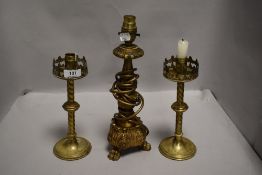 A pair of twisted and knopped brass candlesticks, together with an acanthus carved giltwood table
