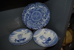 A pair of decorative Delft style wall plates, together with a Japanese blue and white plate (AF)