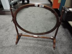 An antique dressing table tilt top mirror with turned mahogany frame