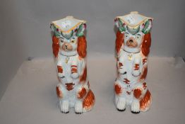 A pair of early 20th century Staffordshire dog jugs.