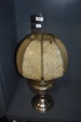 An Aladdin Industries Chromed paraffin lamp, the shade comprised of stitched cellulose panels