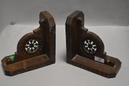 Two stained satin wood wall sconces or book ends having carved decoration and having knopped