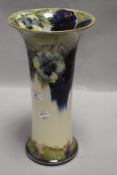 A large flared cylindrical Moorcroft vase,circa 1920, having cream and sage green ground with tube