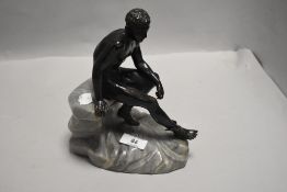 A cold painted figure,circa 1930s, Hermes on marble rock formation.