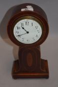 An Edwardian mahogany inlaid clock of balloon form.