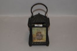 An early 20th century lantern having red glass,pictorial and porcelain inserts.
