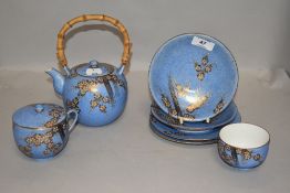 A Chinese porcelain teapot,lidded mug,tea bowl and plates, having dappled blue ground and gilt