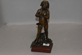 After Jean Louis Gregoire, A 19th century French Zamak figurine depicting a young boy playing a