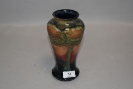 A Moorcroft Eventide vase circa 1925,having tube lined tree pattern to green,blue and orange and red