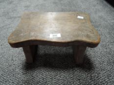 A small carved oak foot or milking stool