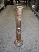 A turned wood and brass Indian temple candlestick.