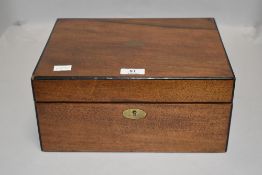 A Victorian veneered mahogany writing slope having compartmental interior including ink well.