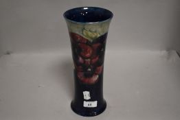 A tall fluted Moorcroft vase,circa 1916, having cobalt blue and sage green ground with burgundy