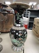 A 19th century Chinese 'Famille Noire' baluster vase, decorated with flora & fauna within