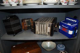 A selection of concertinas and melodeons including vintage examples.