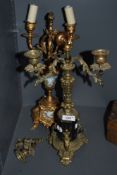 A Victorian brass and black slate candle garniture and similar having hand painted panels.