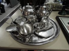 A selection of stainless table ware including tea pots,cruet and more.