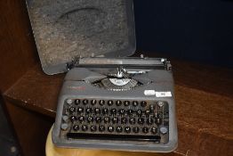 A 1950's Hermes 'Baby' typewriter, in textured grey