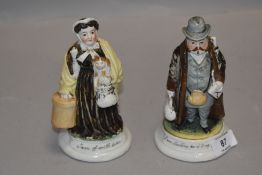A pair of late 19th century continental bisque match strikers,gent with bag and umbrella with 'I