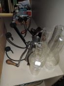A selection of hardware including lamp chimneys and mincers