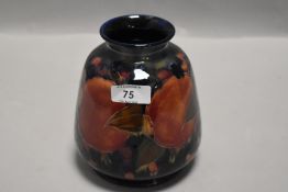 A Moorcroft vase,circa 1930 having cobalt blue ground and tube lined pomegranate pattern with