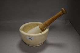 A ceramic pestle and mortar, fine cracks to pestle
