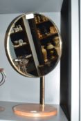 A mid century brass and teak vanity mirror, of circular form with ball and socket adjustment, teak