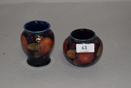 Two Moorcroft pomegranate vases,circa 1930s,having blue grounds with tube lined pomegranate and