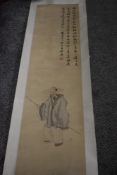 A Chinese paper scroll having painting of gent in traditional dress and symbols.