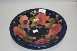 A Moorcroft bowl circa 1930, having cobalt blue ground and tube lined pomegranate and fruit design.