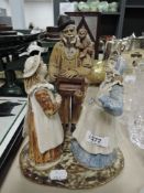 A Rosseau figurine depicting man with monkey and music box and two girls.AF