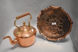 An embossed and punched tray having crimped and folded edge sold with a large copper kettle.