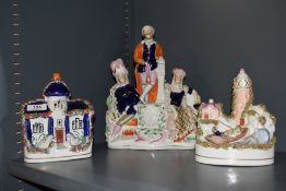 A group of three Staffordshire pottery groups, to include lighthouse scene, cottage and Highland