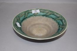 An arts and crafts style bowl by Royal Lancastrian pottery having green glaze marked ETR to base