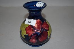 A Moorcroft vase, circa 1960s/70s having blue ground and tube lined Hibiscus design in yellows,