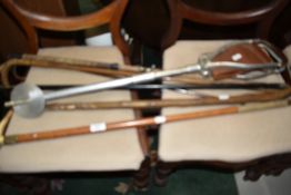 A selection of vintage walking canes, shooting stick etc