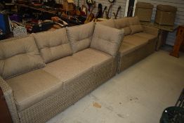 A good quality modern garden set comprising two three seater settees , table and two footstools,