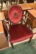 A classical style armchair having shield back, upholstered in burgundy dralon seat and back