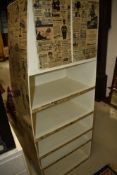 An interestering industrial/commercial shelf unit with upper cupboard, having vintage newspaper